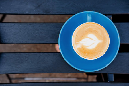 Cup of cappuccino coffee on wooden tableの写真素材