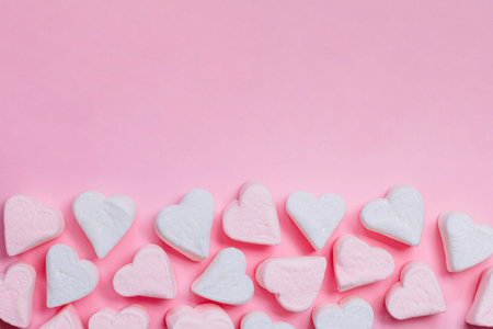 Pink marshmallow hearts on a pink background. The concept of Valentine's Day. February 14.の写真素材