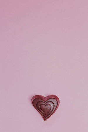 Chocolate hearts on a pink background. The concept of Valentine's Day. February 14.