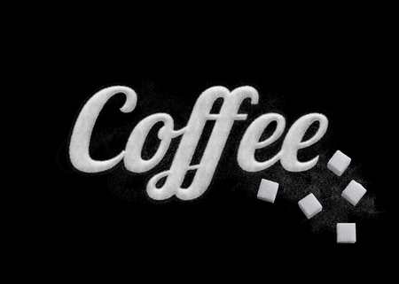 The word Coffee written by sugar grains with sugar cube on elegance design on black background.の写真素材