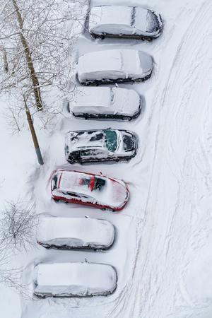 Cars covered in snow on a parking. Top view.の写真素材