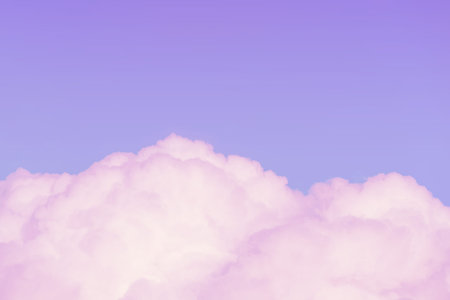 Pink fluffy clouds against a gently violet sky with copy space (background)の写真素材