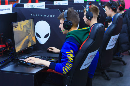 Moscow, Russia, April, 2018: Young gamers in headphones playing at the computer on a e-sport...