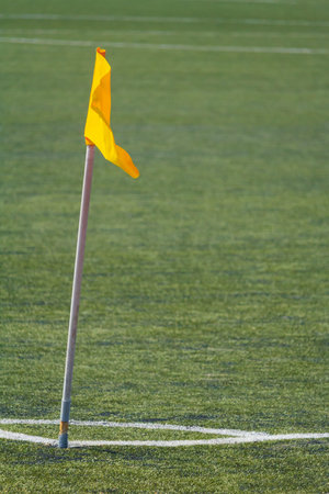 Close up view of a yellow corner flag on the football field