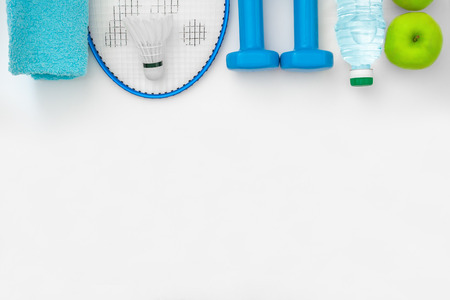 Top view on a attributes of a healthy lifestyle: food, sports equipment on a white background with copy space (flat lay,  concept)の写真素材