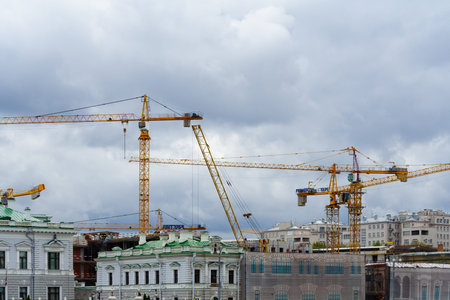 Moscow, Russia, August 2018: General view on a tower cranes in the city center against a gray overcast sky (editorial)のeditorial素材