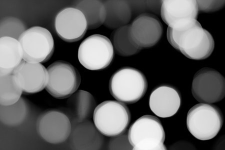 Abstract shiny bokeh lights, isolated on a black background