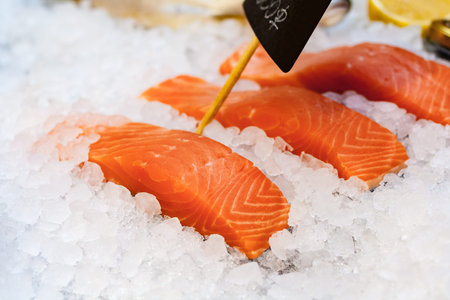 Close up view on a slice of red fish with ice on the counter