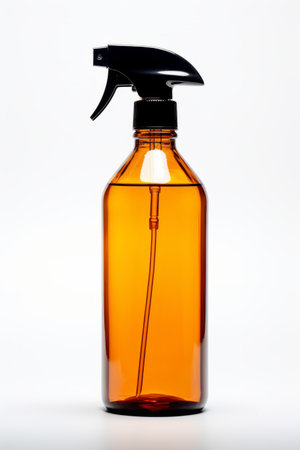 A brown plastic spray bottle with black cap and empty space for mock up, on a white studio backgroundの素材