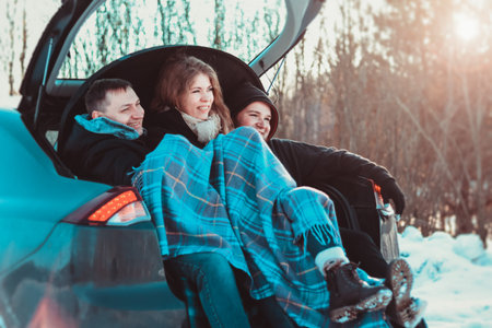 Enjoying road trip with best friends. Group of young cheerful people enjoying their road trip in car...