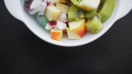 Close up desert with fresh fruit and ice cream. Mixed Fruit With Ice Cream and fruit ice on black backgroundの写真素材