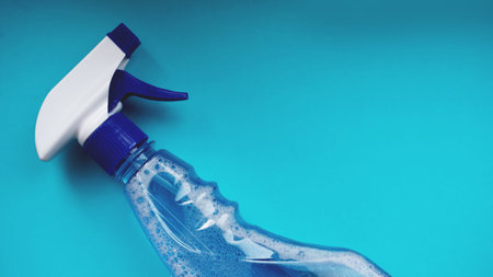 Spray with detergent on blue background. Housework, housekeeping and household conceptの写真素材
