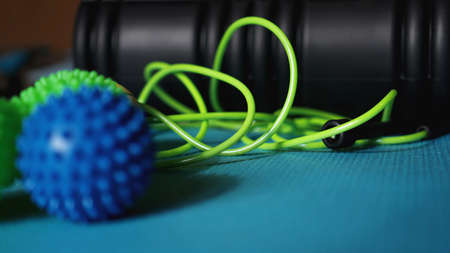 Massage ball and roller for self massage, reflexology and myofascial release, blue background. Equipment for sports, yoga, fitnessの写真素材