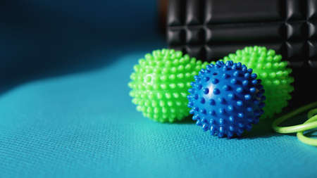 Massage ball and roller for self massage, reflexology and myofascial release, blue background. Equipment for sports, yoga, fitnessの写真素材