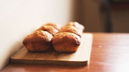 Six delicious home-made muffins on a wooden background. Dessert for gourmet. Selective focusの写真素材