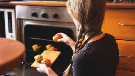 Close-up muffins ready to get out of electric oven. Concept of cooking home cake. Tasty food.の写真素材