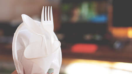 Hands break plastic dishes, people ban and stop using plastics garbage. Concept of Recycling plastic and ecology - blurred backgroundの写真素材