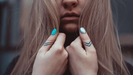 The lady hand with tattoo, small tattoo, closeup photoの写真素材