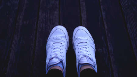 Fashion hipster cool woman with white sneakers, vintage toned colors great for any use.の写真素材