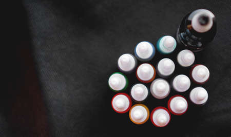 Many professional bottles with colored ink for tattoos - black backgroundの写真素材
