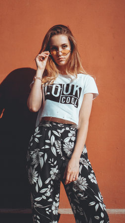 Fashion portrait stylish pretty woman in sunglasses posing in the city, street fashion. You look...