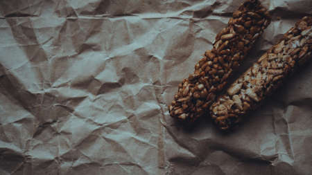 Homemade wholegrain cookies with oatmeal and sesame seeds on craft paper. Food photo. Recipe book, copy space. Healthy vegan wholegrain cookies.の写真素材