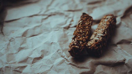 Homemade wholegrain cookies with oatmeal and sesame seeds on craft paper. Food photo. Recipe book, copy space. Healthy vegan wholegrain cookies.の写真素材