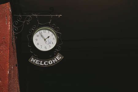 Clock with label Welcome. Red courtyard in Minskの写真素材
