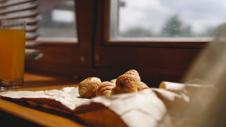 French breakfast with croissant, kraft crockery on kraft paper. Mini croissants