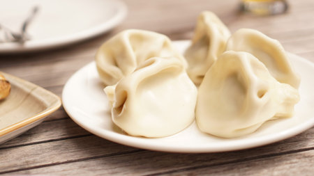 Georgian dumplings Khinkali with meat on white plate close-up