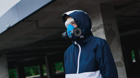 Protection respirator half mask for toxic gas.The man prepare to wear protection air pollution in...