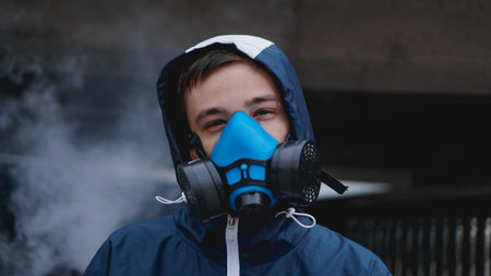 Protection respirator half mask for toxic gas.The man prepare to wear protection air pollution in...