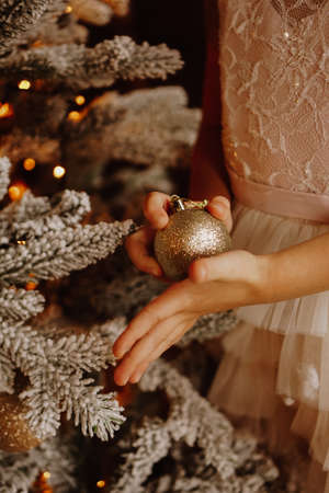 A child holding Christmas ball. Christmas vertical card design. Copy space. Close-upの写真素材