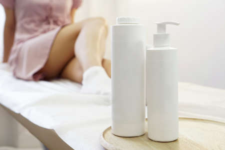 Body care. Young woman with smooth healthy skin of the legs. Means against varicose veins and edema in the foregroundの写真素材