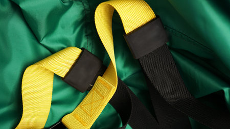 Closeup view of suspension on green background training at home - Fitness at home