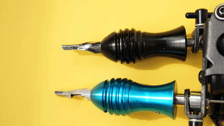 Two tattoo machines on a yellow background - tattoo industryの写真素材
