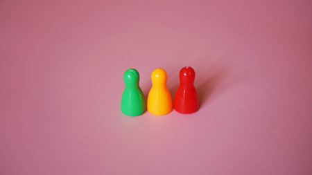 Board game figures on bright pink background