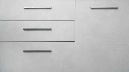 Front side of kitchen cabinet with drawers - modern grey interiorの写真素材