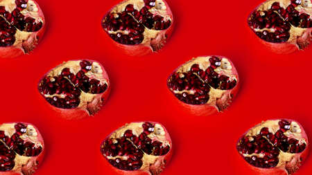 Pattern of red pomegranates in rows on red background, fruit lines backdrop, stripes garnet fruits art wallpaperの写真素材