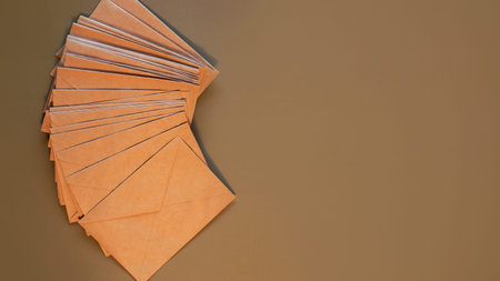 Brown craft envelopes on a gray background. Top view, flat lay