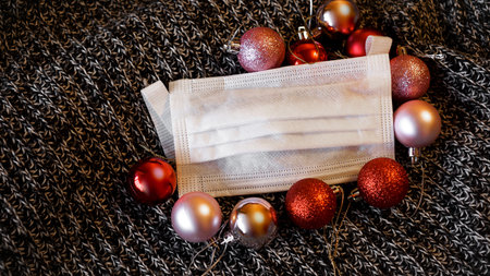 Medical mask with Christmas balls. Corona virus . New year on quarantine. Copy Space