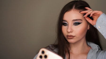 Young attractive model make a selfie after makeup in beauty studio.