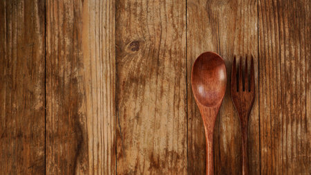 Wooden spoon and fork on wooden background. Asian style wooden appliances. Copy spaceの写真素材