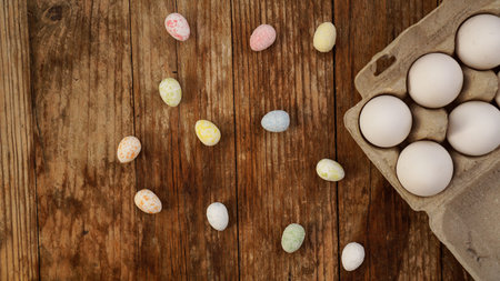 Chicken eggs in a cardboard tray and Easter decor on a wooden background., Rural Style