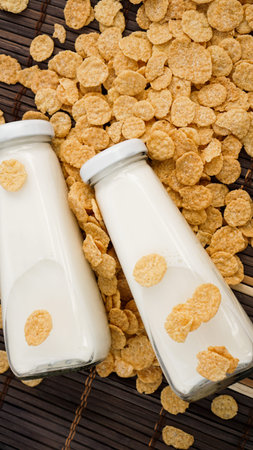 Milk in Glasses Bottles with cornflakes, Dairy Produce Concept of Breakfast