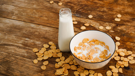 Healthy eating background. Fresh milk in bowl with cornflakes
