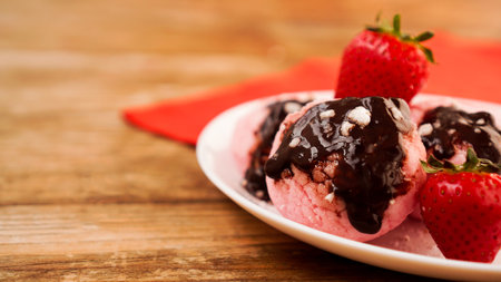Homemade strawberry ice cream on white plate on a rustic background.の写真素材