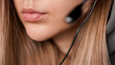 Closeup portrait of female lips and black headset. Call centerの写真素材
