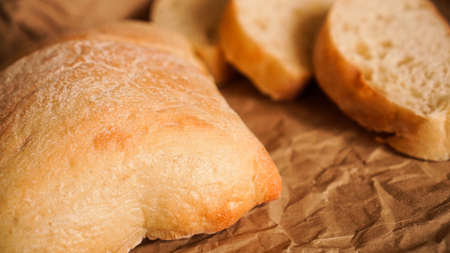 Ciabatta slices on craft paper. Fresh delicious pastries. Fresh homemade bread.の写真素材