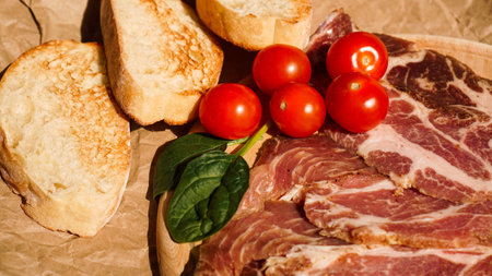 Bread slices, cherry tomatoes, spinach and ham. Ingredientsの写真素材